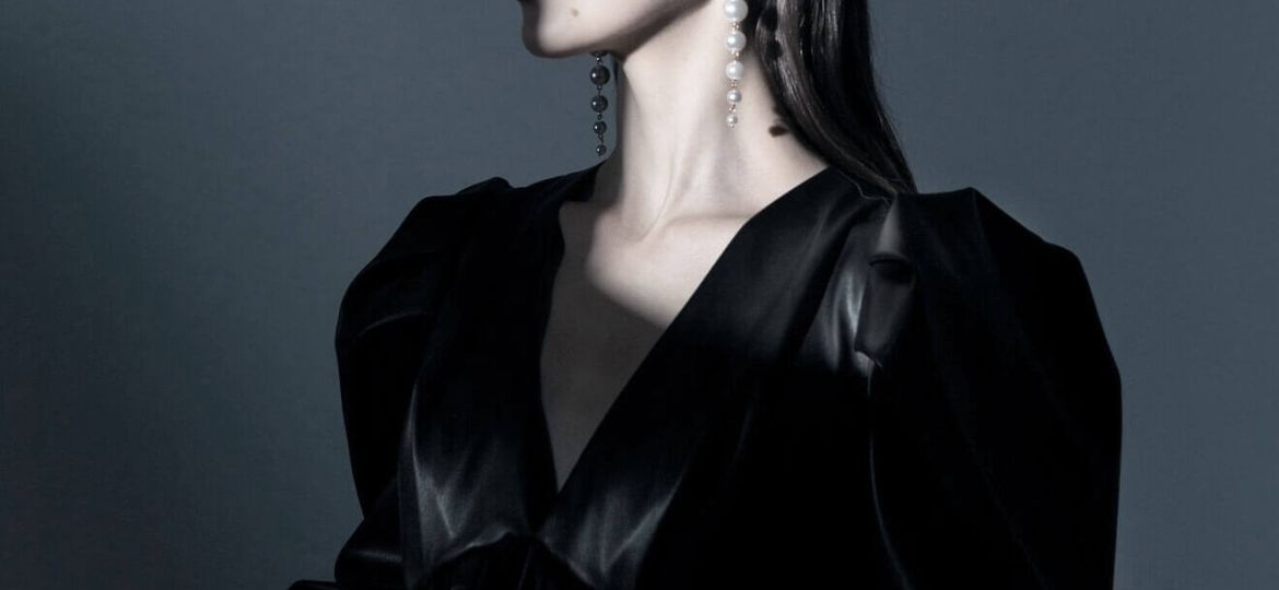 Woman in black satin dress, dreaming.