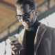 Man smiling while looking at his smartphone