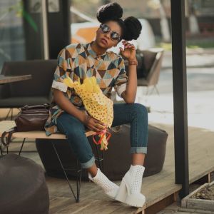 Stylish young woman with flowers, ready to leave.