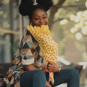 Happy young woman with yellow tulips