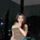 Aimi, a Malay girl, in a brown top and jeans, enjoying a city view. Malaysia escort service.