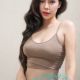 Attractive young woman in a beige top and blue underwear. KL Sex Girl.