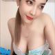 Attractive young woman in a white top, available for outcall escort services.