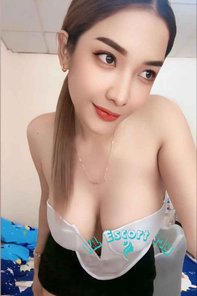 Attractive young woman in a white top and black skirt. KL Escort My