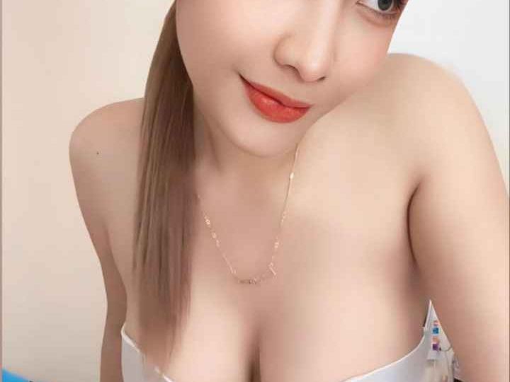 Attractive young woman in a white top and black skirt. KL Escort My
