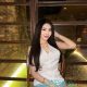 Aimi, a Malay girl, in a white top and jeans. Malaysia escort service.