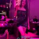 Attractive Malay woman in a black dress at a bar.