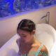 Aiza, a Malaysia escort model, relaxes in a bubble bath.