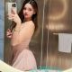 Aiza, a Malaysia escort model, poses in a pink dress.