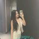 Young Malay woman taking a selfie in a restroom.