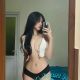 Attractive Chinese woman in a white top and black underwear.