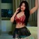 Shazana, KL Escort Outcall, in a red top and black skirt.