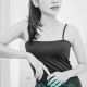 Attractive woman in a black dress, offering incall and outcall escort services.