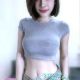 Attractive young woman in a grey crop top and jeans. Local escort.