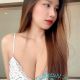 Attractive young woman in a floral top. Best escort girl services.