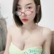 Attractive young woman wearing a yellow dress and glasses. Local escort.