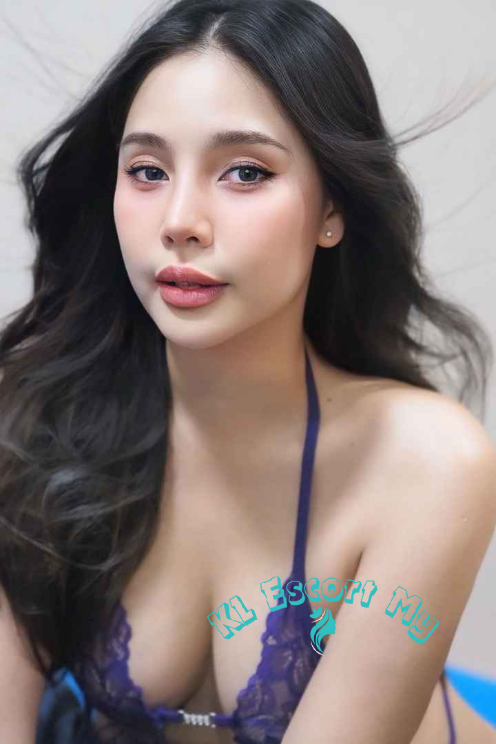 Attractive young woman in a purple lace bra. KL Escort My.