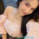 Attractive young woman in pink top and jeans. KL Escort.