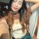 Attractive young woman in brown and beige top and black shorts. Incall and outcall escort services.