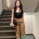 Stylish woman in khaki pants and black top, KL escort.