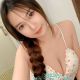 Attractive young woman in a white camisole. Best escort girl services.