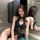Qian, a Kuala Lumpur escort, poses in a black lace bodysuit.