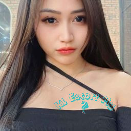 Attractive young woman with long dark hair, wearing a black off-the-shoulder top. KL Escort My