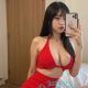 Attractive young woman in red lingerie, taking a selfie.