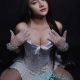 Attractive Malay woman in a white corset and gloves.